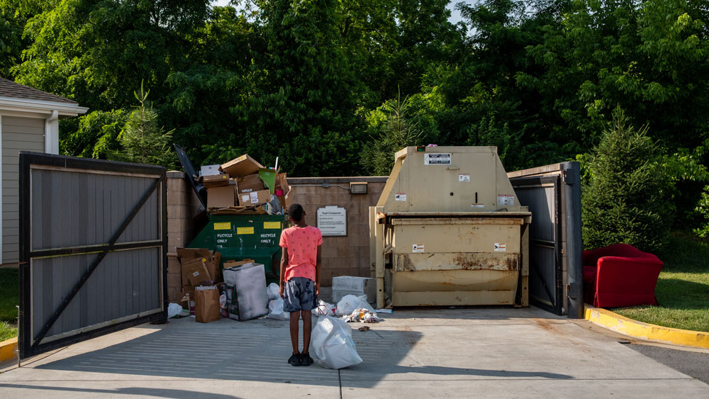 Overflowing dumpster and bulky trash